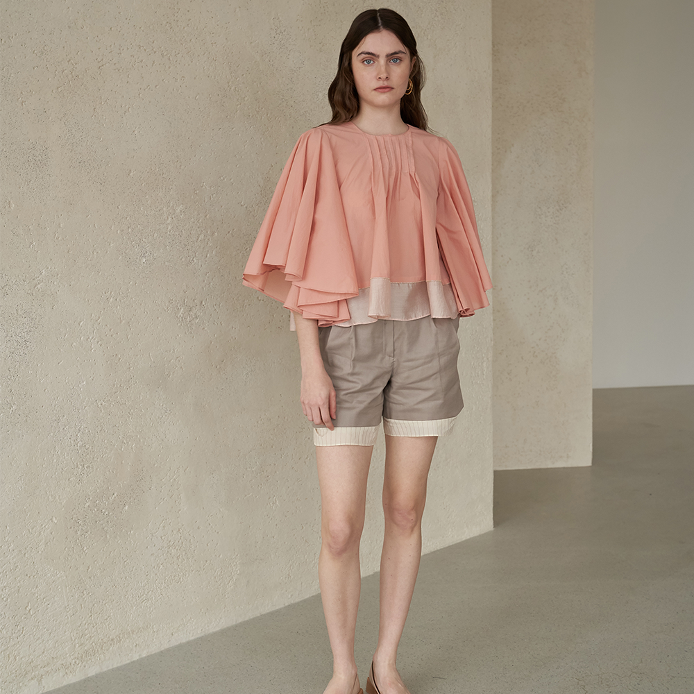 Light apricot colored winged blouse