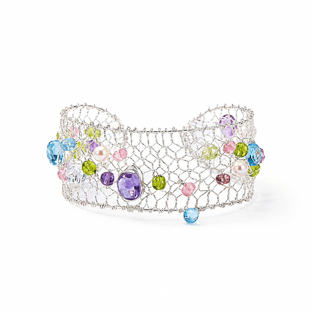 Discover the Celestia Multi-Gemstone & Pearl Silver Mesh Bracelet at The Luxe Maison, featuring luminous pearls, blue topaz, amethyst, and tourmaline woven into an elegant silver mesh design for a celestial touch.