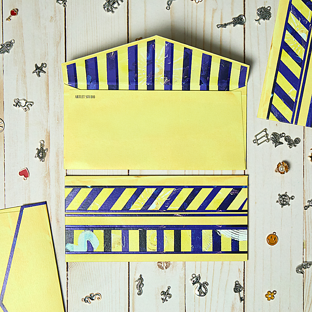 Discover Charm Pockets Envelopes at The Luxe Maison, featuring blue stripes, seven symbolic charms, and premium textured paper. Pack of 10, made in Dubai.