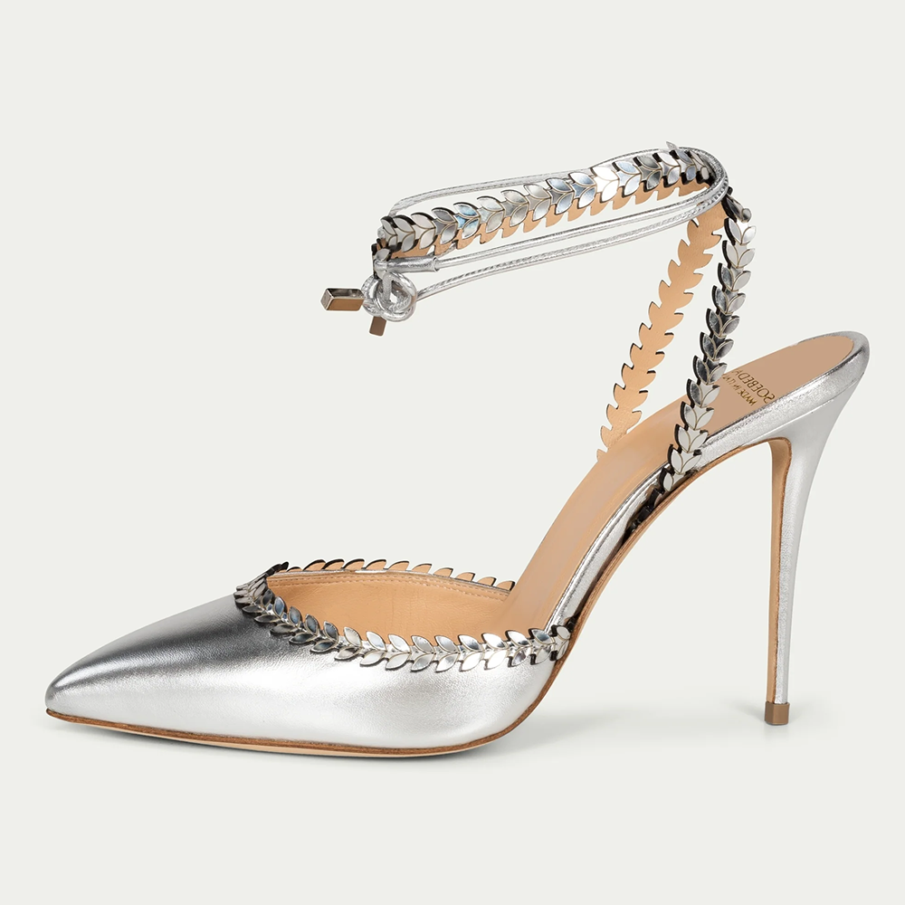 This silver shiny leather pump with laser foliage strap is hand-finished in Italy. Pointed toe. 