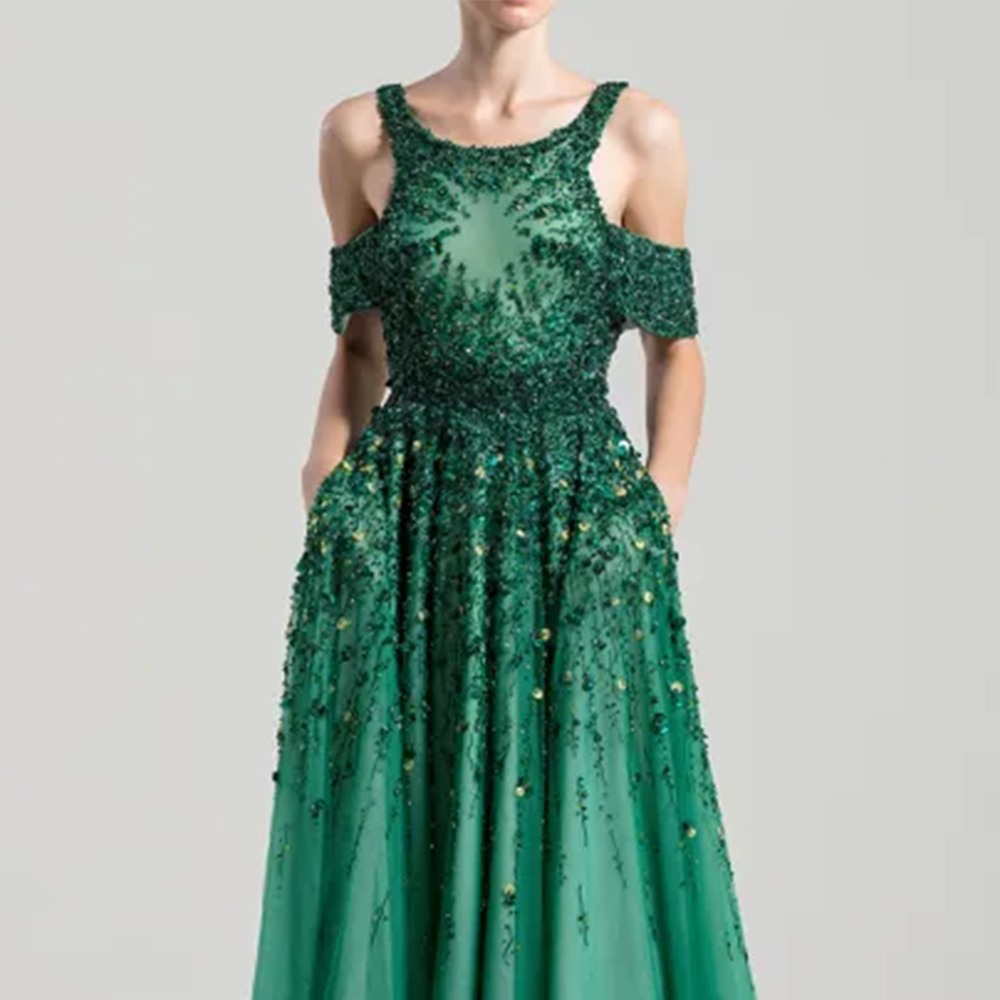 Ankle length dress with wide shoulder straps and off- shoulder tulle bands, fully beaded on top.