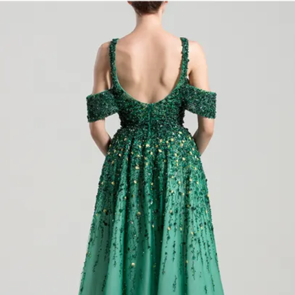 Ankle length dress with wide shoulder straps and off- shoulder tulle bands, fully beaded on top.