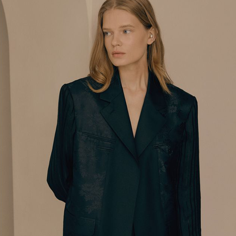 Raw-edged, Round neckline One side handkerchief-hem with patch pocket Adjustable tie belt at waist Relaxed silhouette.