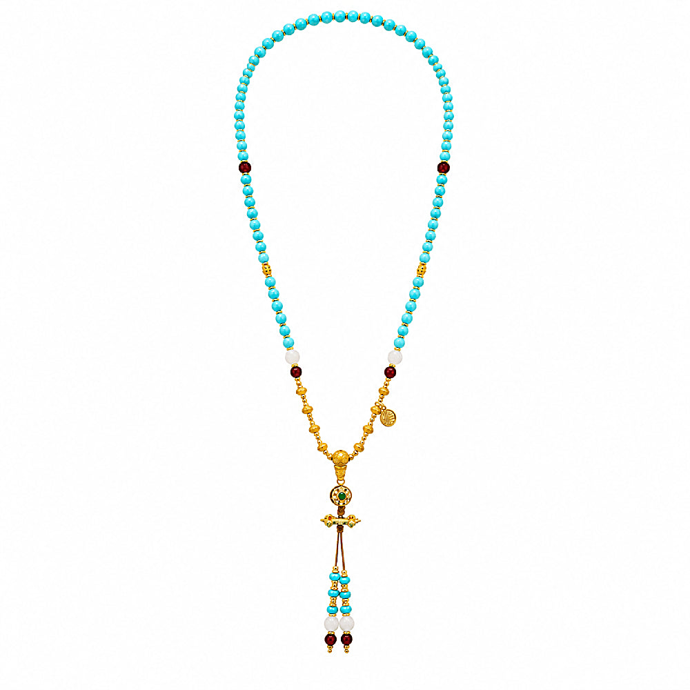 Discover the Dakini Blue Turquoise & Carnelian Beaded Tassel Necklace at The Luxe Maison, featuring natural turquoise beads, warm carnelian accents, and a golden vajra for a spiritual, bohemian touch.