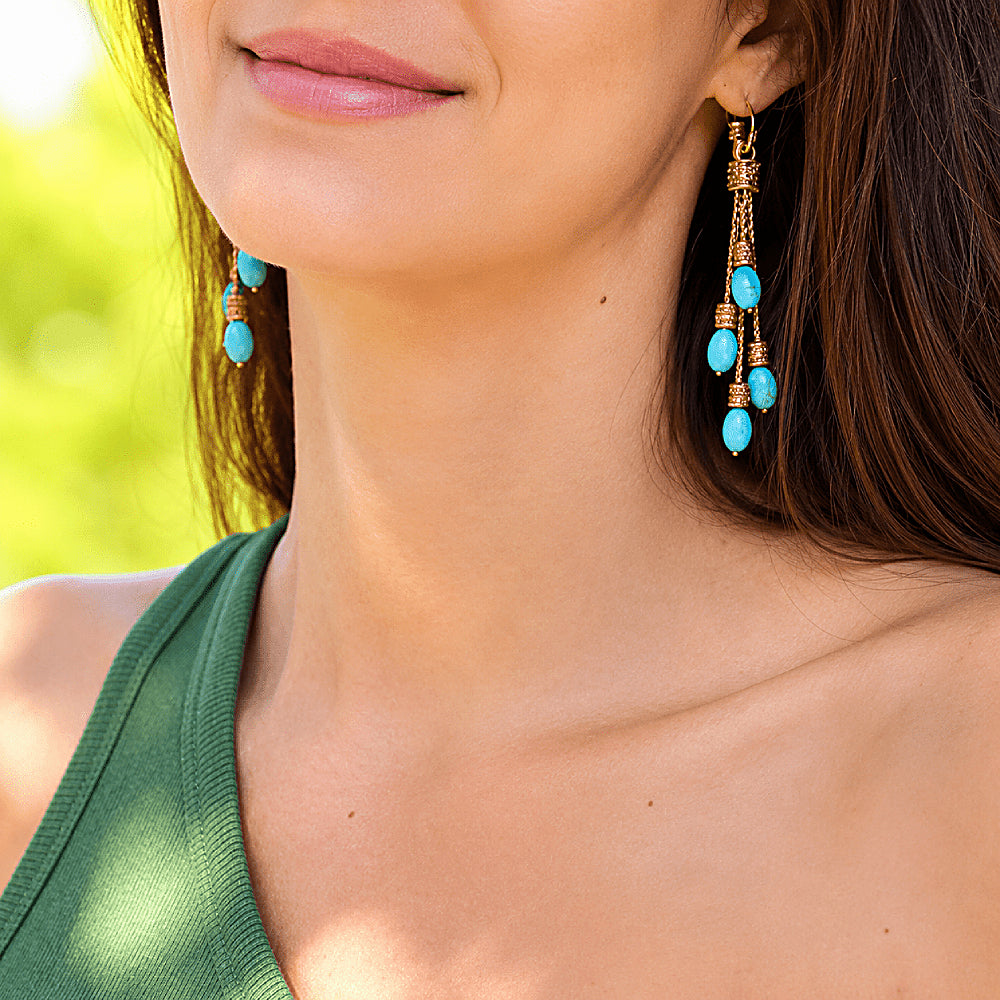 Discover the Dakini Turquoise Tassel Earrings at The Luxe Maison, featuring cascading strands of vibrant turquoise inspired by the celestial sky dancers of the Himalayas. With their graceful movement and mystical charm, these statement earrings add a touch of bohemian elegance to everyday outfits and special occasions.