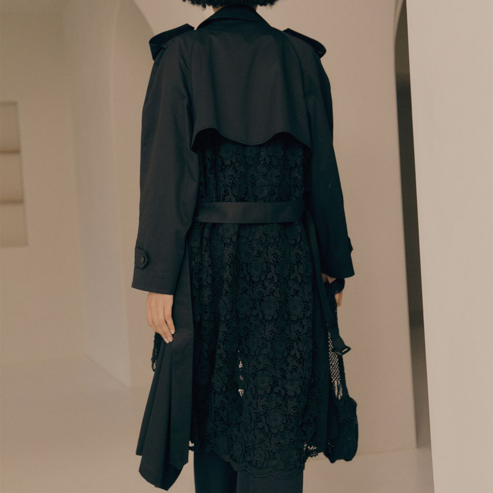 Raw-edged, Round neckline One side handkerchief-hem with patch pocket Adjustable tie belt at waist Relaxed silhouette.