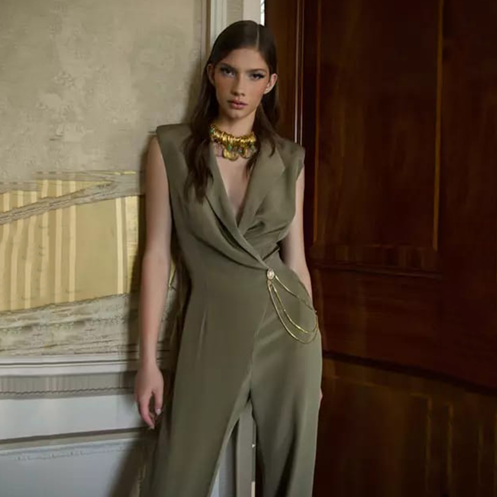 The finest silk in olive Asymmetrical Fitted waistline Wide leg Sleeveless Crystal button fastening.