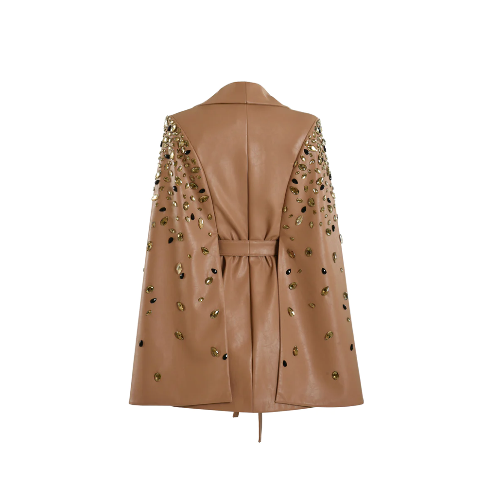 Beige cape coat with embroidered sleeves.