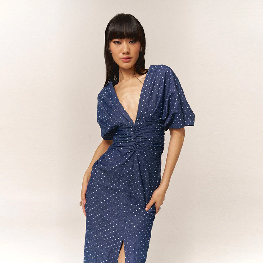 Polka dot denim dress with twisted front & slit hem waist-accentuating, perfect for brunch, birthdays, baby showers & garden parties.