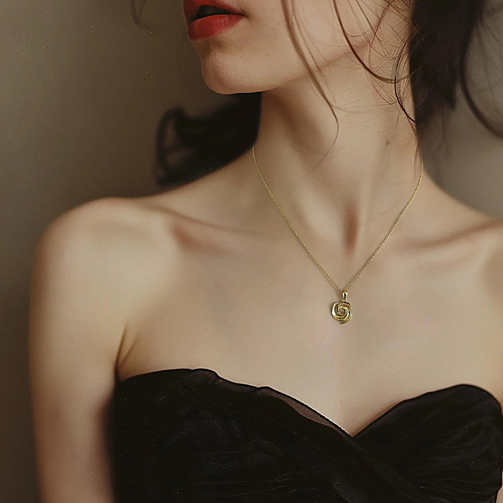Discover the Endless Rose Gold Vermeil Necklace at The Luxe Maison, featuring an intricate spiral pendant inspired by blooming rose petals for a timeless, elegant look symbolizing beauty and grace.