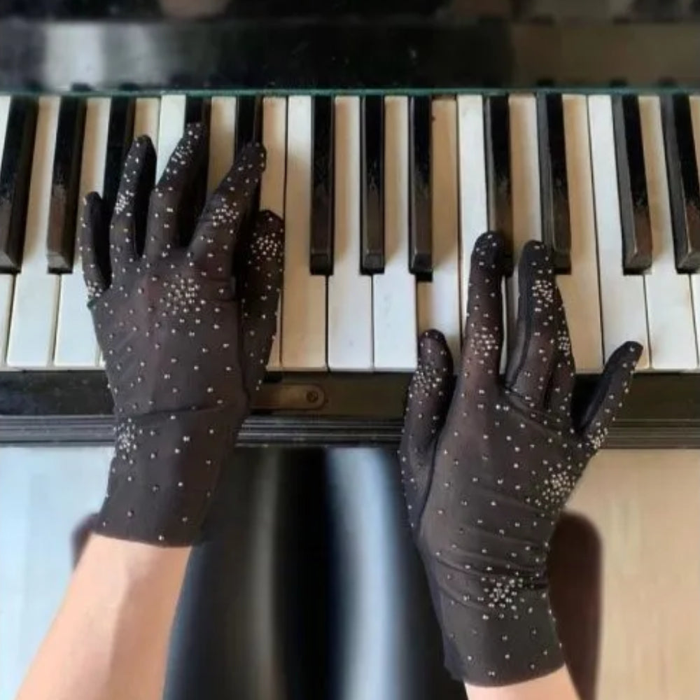 Black gloves from stretch net with salute of gematite crystals. The designer is known for their impeccable craftsmanship.