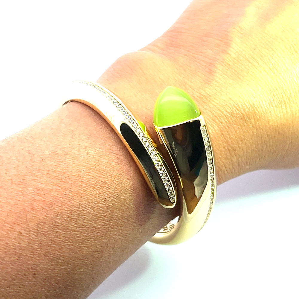 Elegant yellow gold plated cuff bracelet with a colored pyramidal crystal and sparkling pavé cubic zirconia accents. Perfect for luxe everyday styling. Shop premium jewelry online.