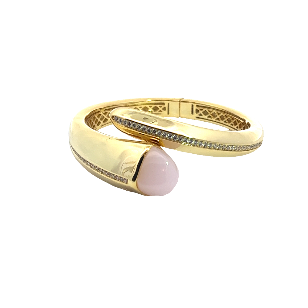 Elegant yellow gold plated cuff bracelet with a colored pyramidal crystal and sparkling pavé cubic zirconia accents. Perfect for luxe everyday styling. Shop premium jewelry online.