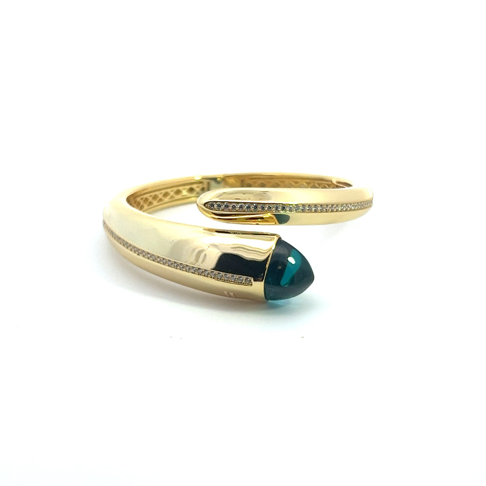 Elegant yellow gold plated cuff bracelet with a colored pyramidal crystal and sparkling pavé cubic zirconia accents. Perfect for luxe everyday styling. Shop premium jewelry online.