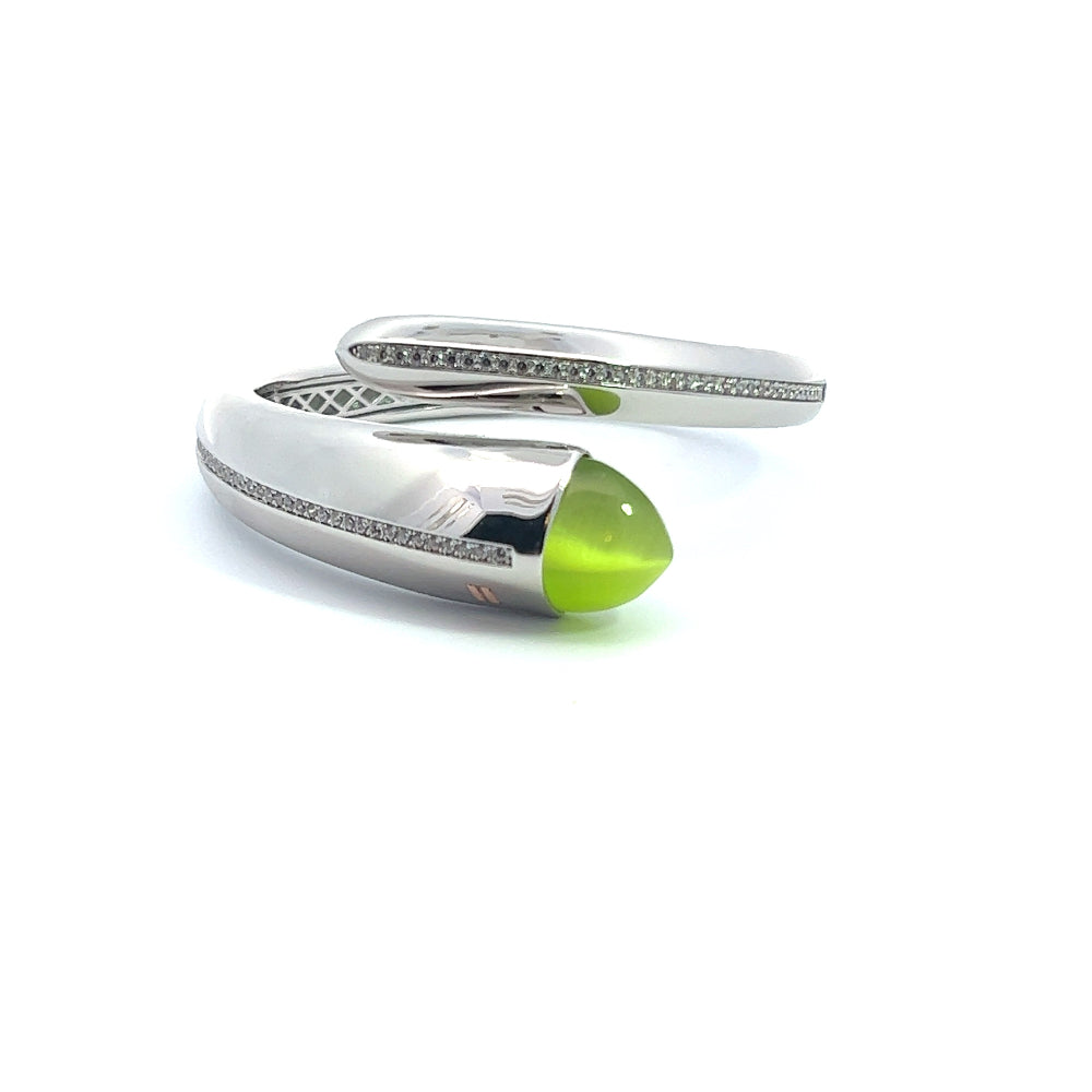 Elegant rhodium plated cuff bracelet with a colored pyramidal crystal and sparkling pavé cubic zirconia accents. A chic luxe accessory for every occasion. Shop premium jewelry online.