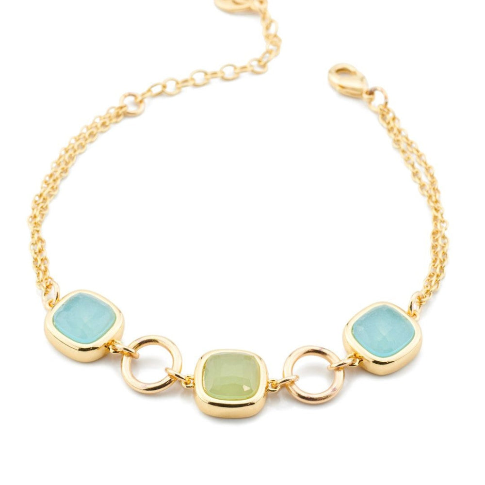 Yellow gold plated bronze bracelet with green and aquamarine crystal accents, detailed with circular gold plated modules for a modern layered look. Shop premium jewelry online.