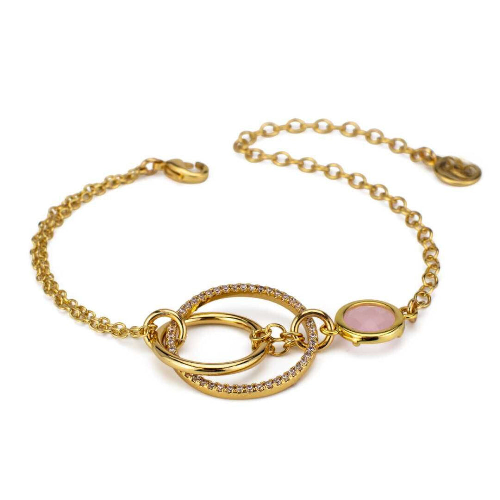 Elegant yellow gold plated bracelet with concentric circle detailing, sparkling cubic zirconia, and a rose quartz-colored stone accent. Shop premium jewelry online.