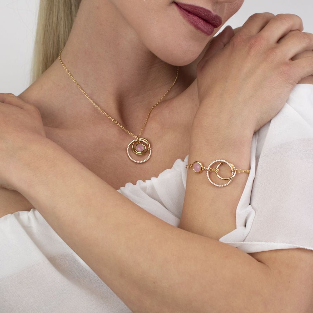 Elegant yellow gold plated modular bracelet with peach briolette-cut crystals, aqua milk, and rose quartz accents for a chic luxe look. Shop premium jewelry online.