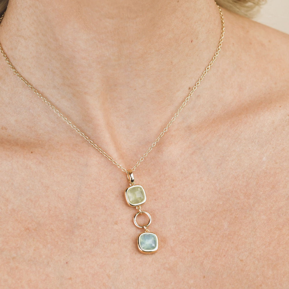 Shop online premium gold plated necklace with green and aquamarine crystals and circular module pendant design.