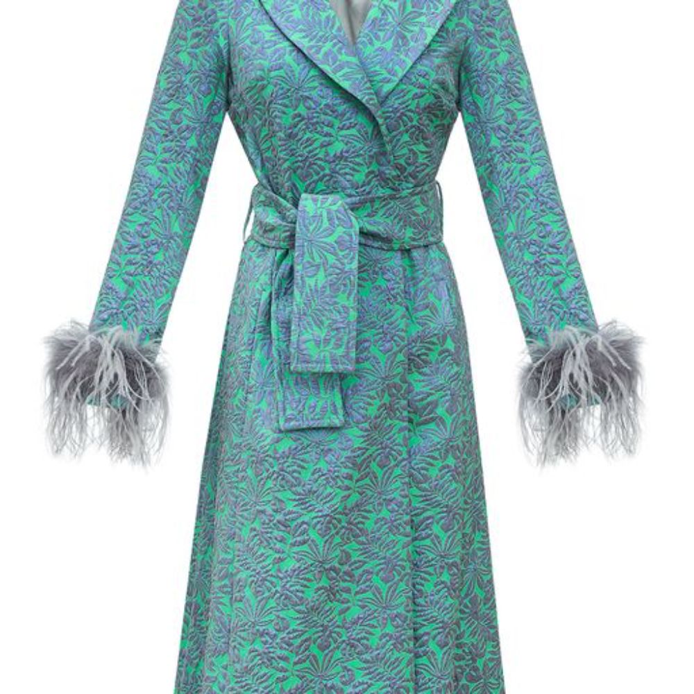 Signature coat has belted waist and decorated with detachable feathers cuffs.