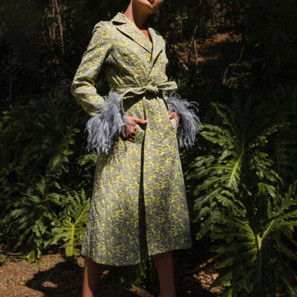 Signature Coat With Detachable Feather Cuffs has printed fabric with an epaulette details. 