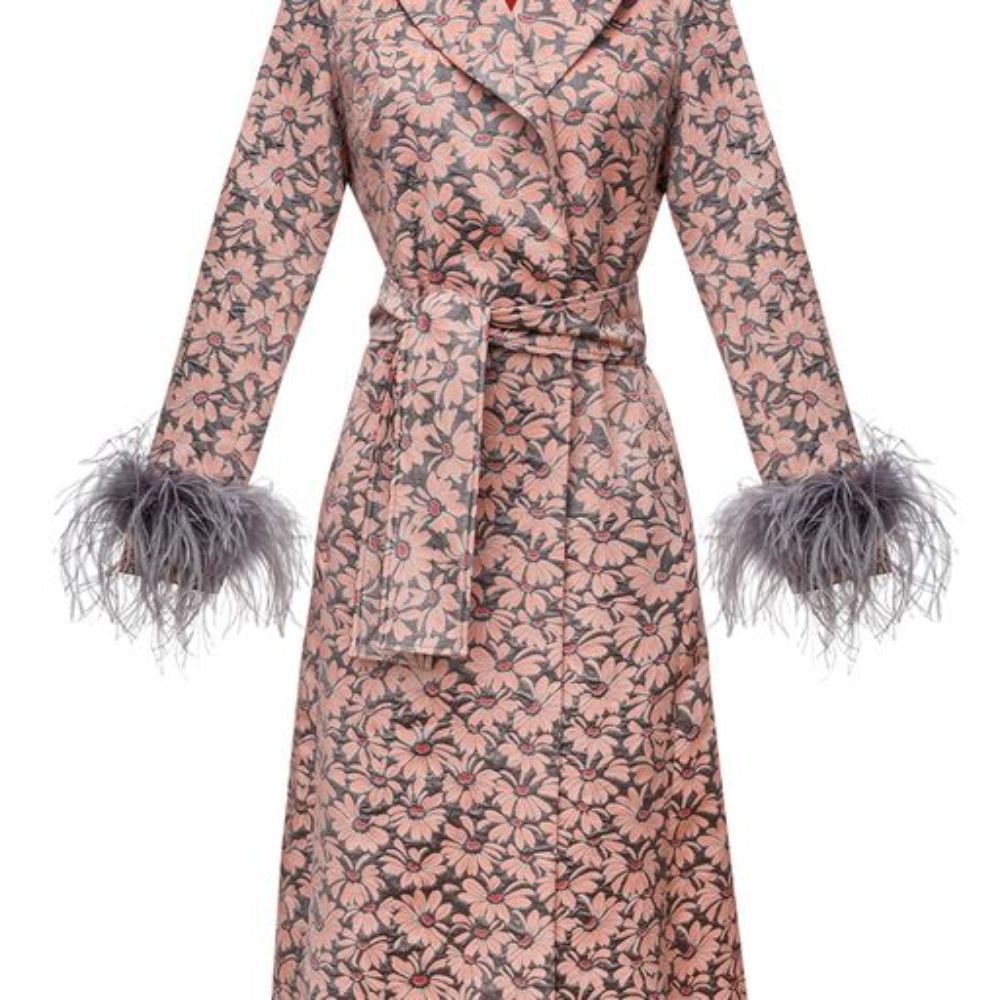 Signature coat has belted waist and decorated with detachable feathers cuffs.
