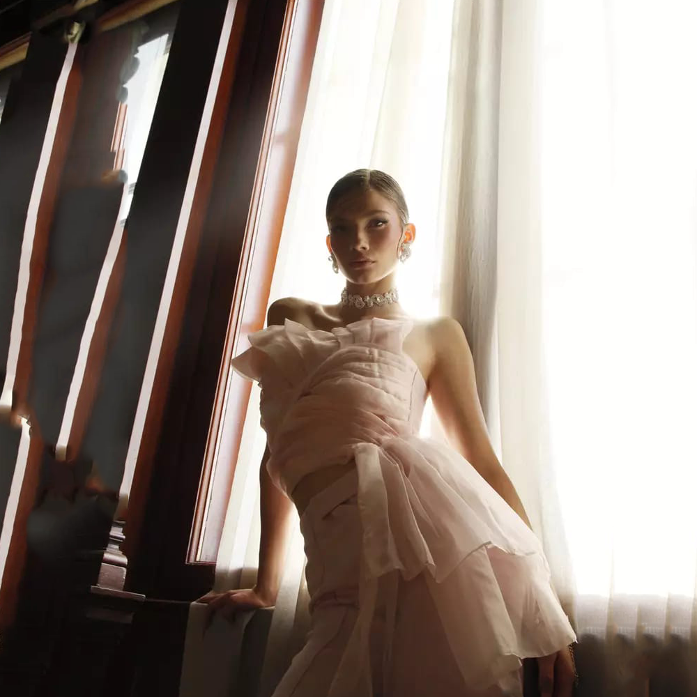 The finest silk in shell pink Asymmetrical draping Artistic expression of wings