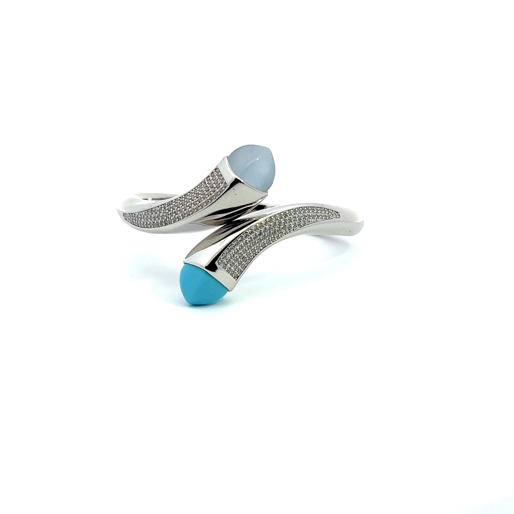 Elegant rhodium plated wrap cuff bracelet with blue chalcedony crystals and pavé cubic zirconia accents. A chic statement piece for every occasion. Shop premium jewelry online.
