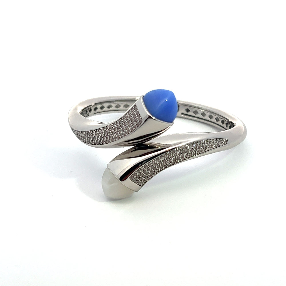 Elegant rhodium plated wrap cuff bracelet with blue chalcedony crystals and pavé cubic zirconia accents. A chic statement piece for every occasion. Shop premium jewelry online.