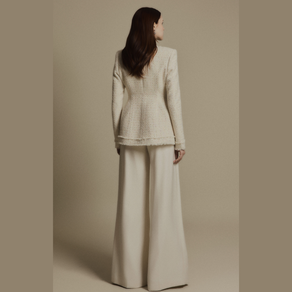 Create a polished look by styling a luxe dress with the elegant Ivory Crest Tweed Jacket. Shop Now!