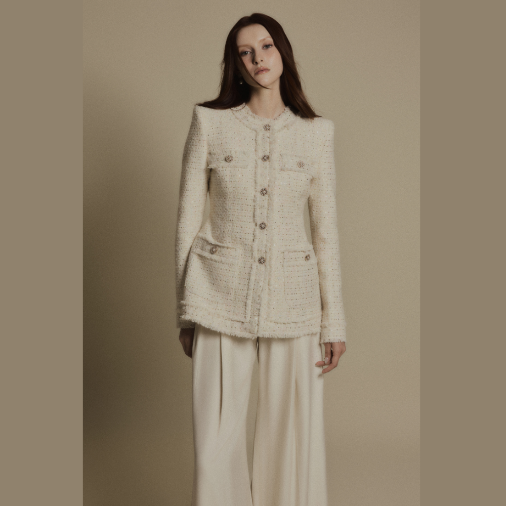 Create a polished look by styling a luxe dress with the elegant Ivory Crest Tweed Jacket. Shop Now!