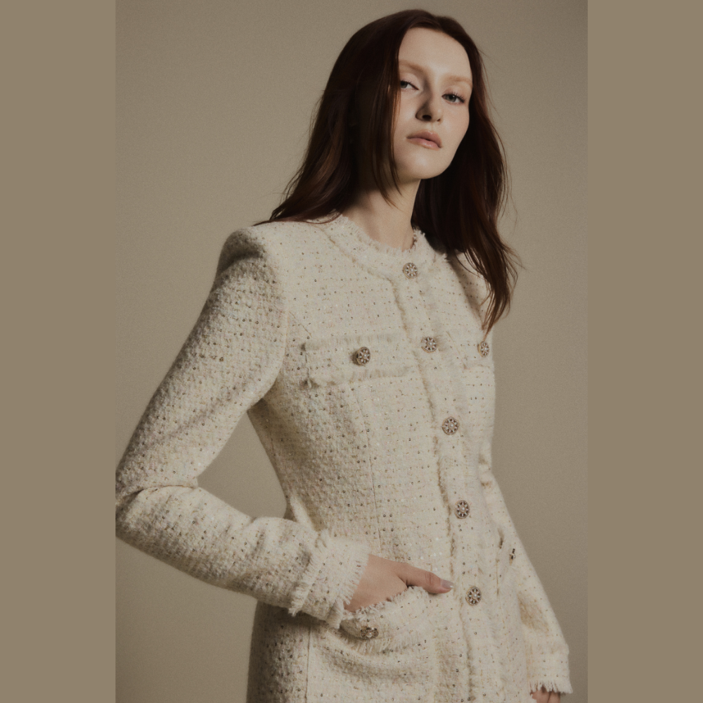 Create a polished look by styling a luxe dress with the elegant Ivory Crest Tweed Jacket. Shop Now!