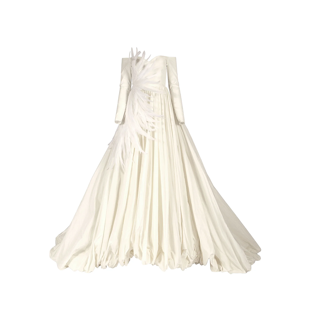 Off-the-shoulder ivory silk taffeta puffball wedding gown featuring plumes emerging at the side waist.