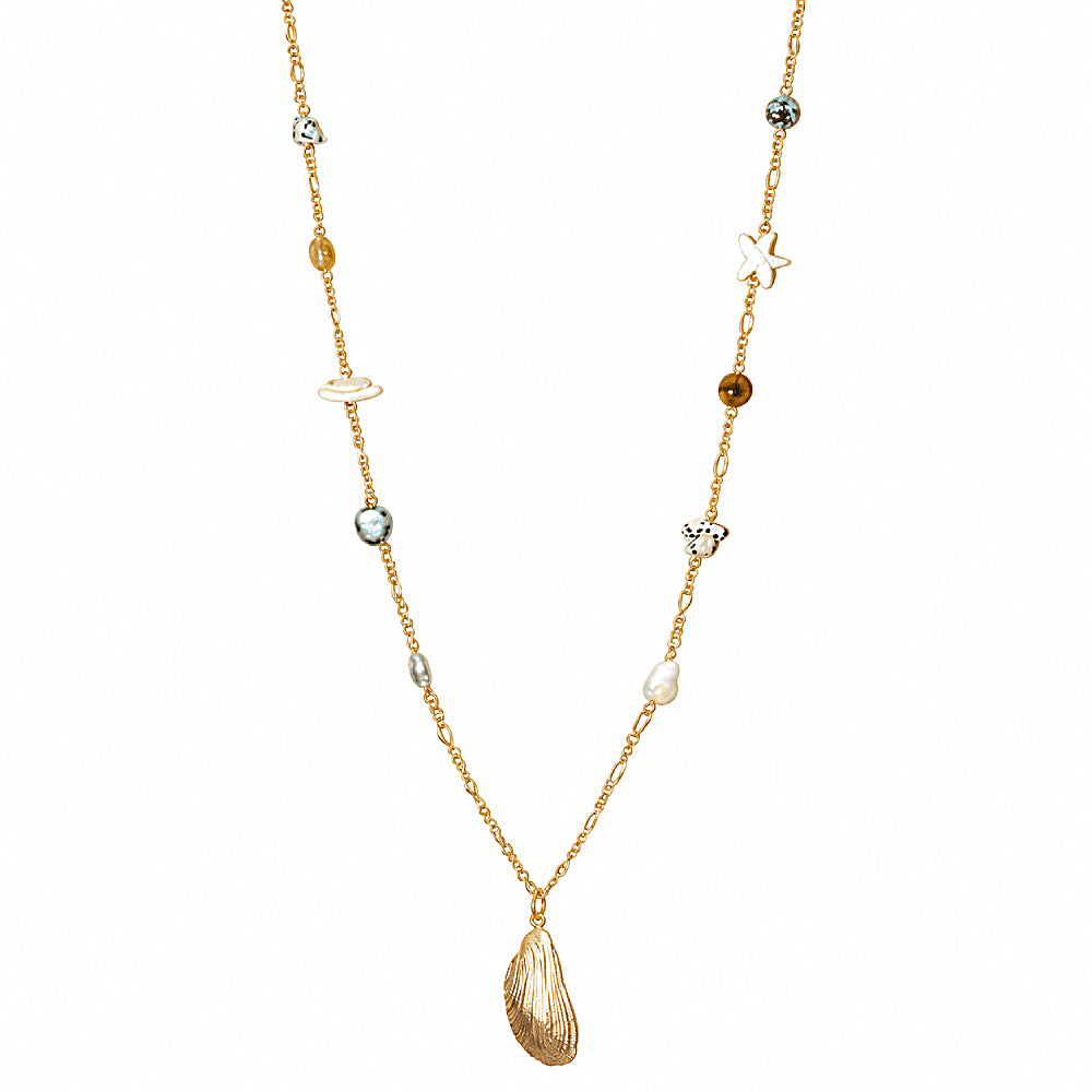 Discover the Kauai Multi-Stone Shell Necklace at The Luxe Maison, featuring Dalmatian jasper, turquoise, golden rutilated quartz, and a gold-plated shell pendant for a vibrant, island-inspired look.