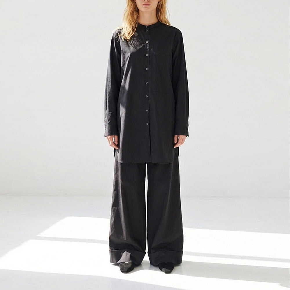 Discover the Kurta Shirt at The Luxe Maison, featuring an oversized fit, stand-up collar, statement pockets, and wide cuffs with mother-of-pearl cufflinks.