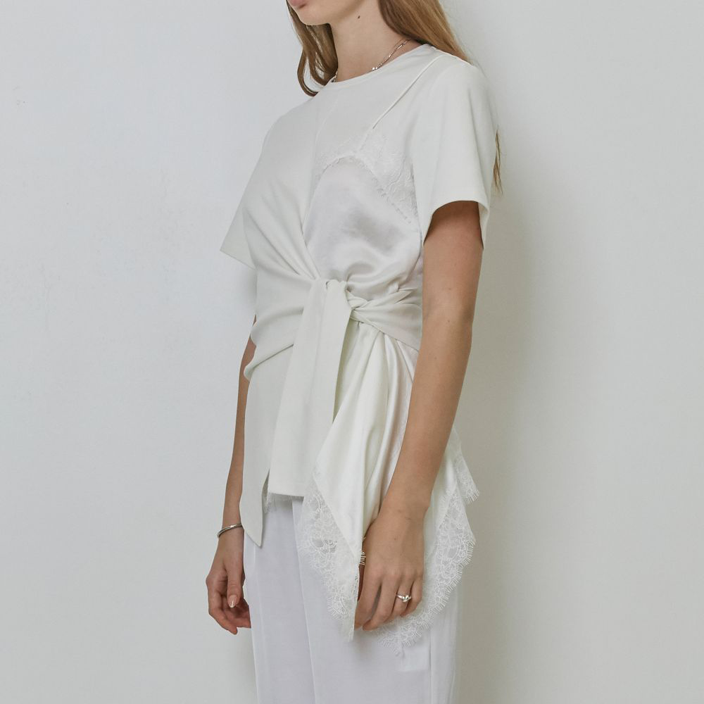 Raw-edged, Round neckline One side handkerchief-hem with patch pocket Adjustable tie belt at waist Relaxed silhouette.