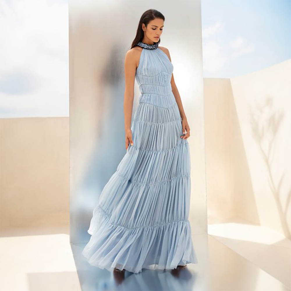 A sky blue chiffon-tiered dress fastened with an embossed choker embroidered with midnight blue crystals.