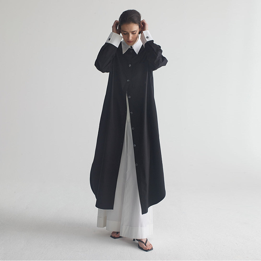 Discover the Liv Caftan at The Luxe Maison, featuring contrasting collar and cuffs, a calf-length silhouette, mother-of-pearl buttons, and side pockets.