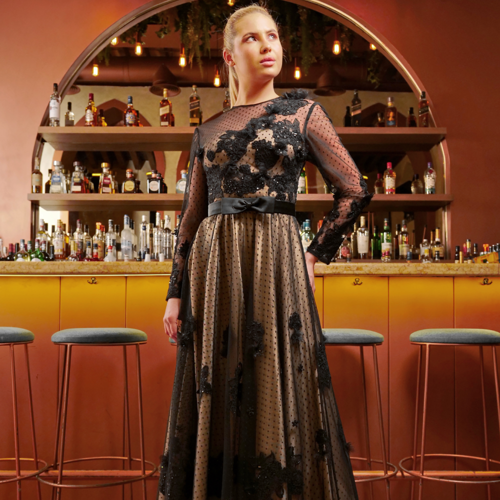 Exquisite long tulle dress adorned with lace and floral embroidery, a blend of elegance and intricate detail.