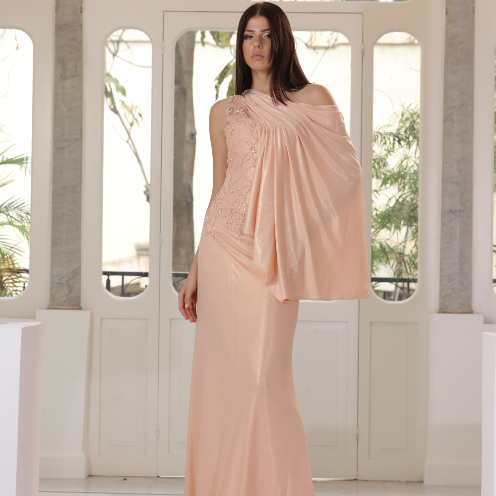 Long salmon jersey dress with embroidered bust and one shoulder drape.