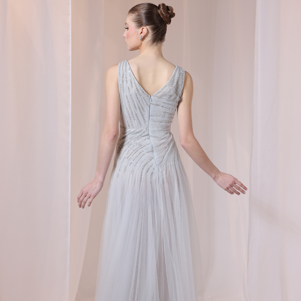 Shop online soft grey gown with delicate V-neckline, subtle shimmer and airy flowing silhouette, perfect for parties and special occasions.