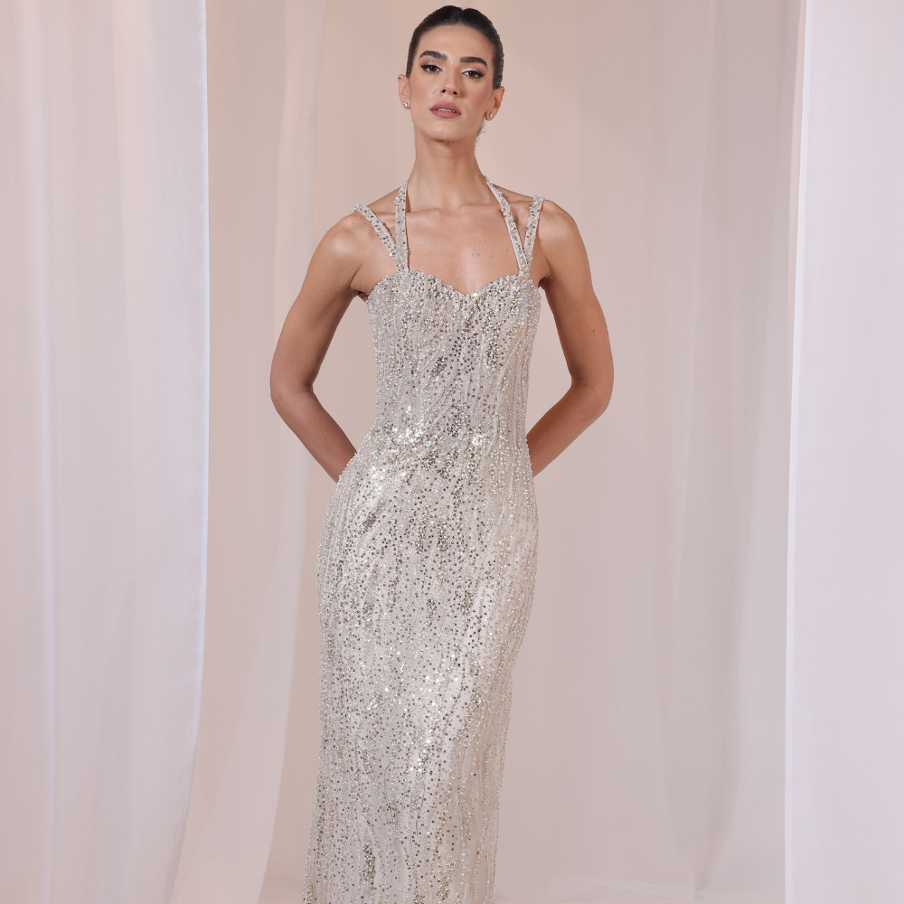 Shop online shimmering gown with delicate straps, intricate beadwork and sleek luminous silhouette, perfect for parties and special occasions.