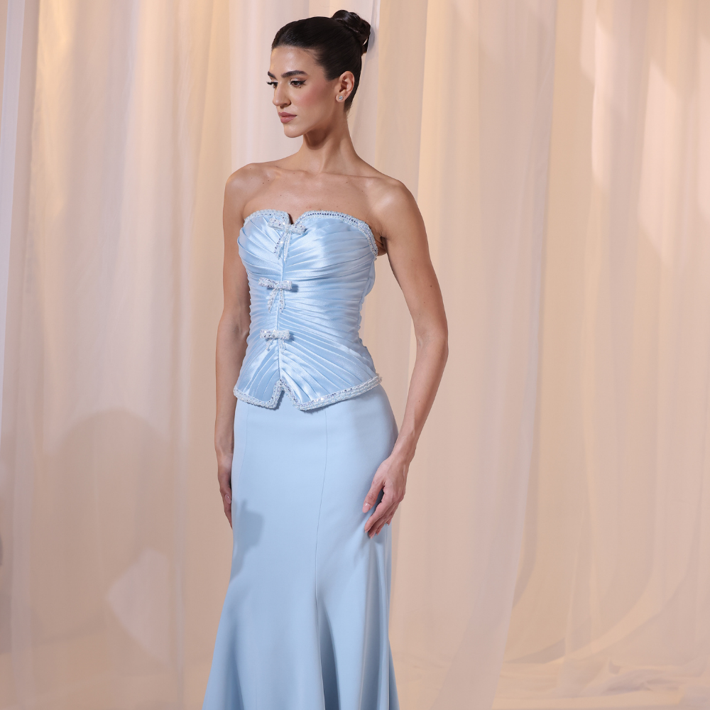 Shop online light blue gown with structured corset bodice, soft pleated details and sleek elegant silhouette, perfect for parties and special occasions.