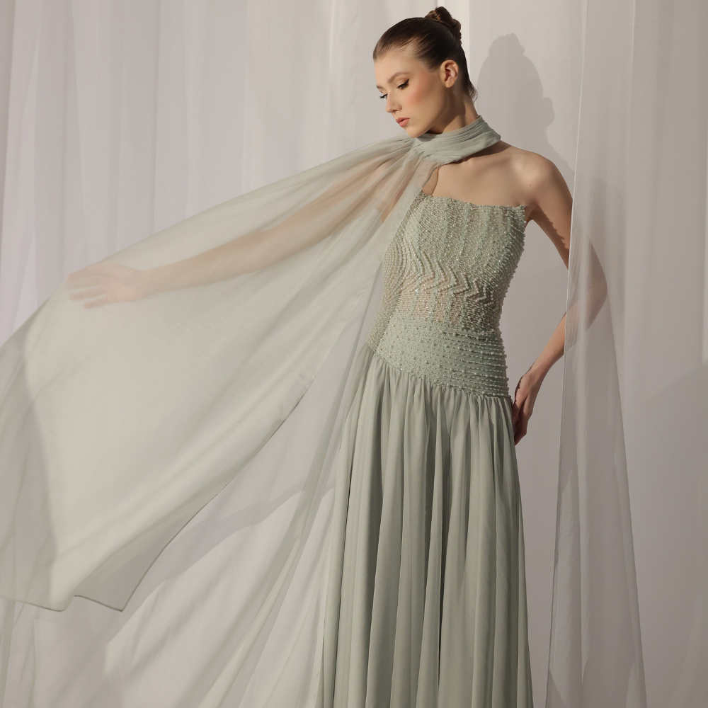 Shop online soft mint gown with shimmering beadwork, sheer draped scarf and flowing silhouette, perfect for parties, receptions and special occasions.
