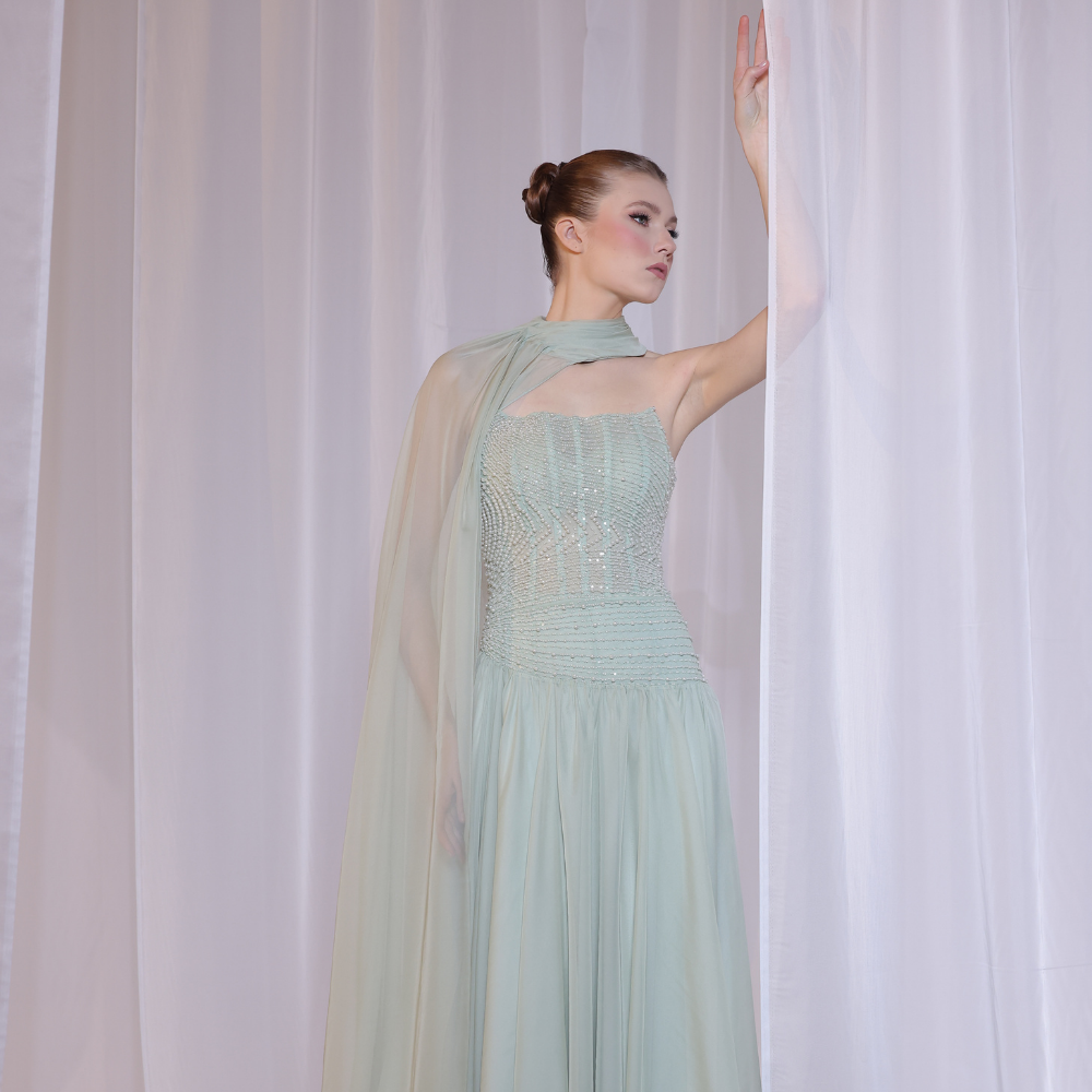 Shop online soft mint gown with shimmering beadwork, sheer draped scarf and flowing silhouette, perfect for parties, receptions and special occasions.