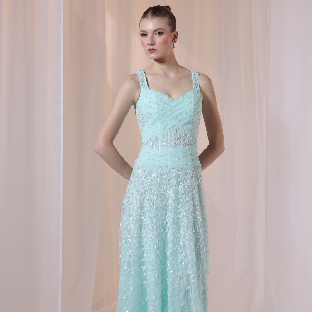 Shop online soft mint gown with structured pleated bodice, delicate shimmer details and flowing embellished skirt, perfect for parties and special occasions.
