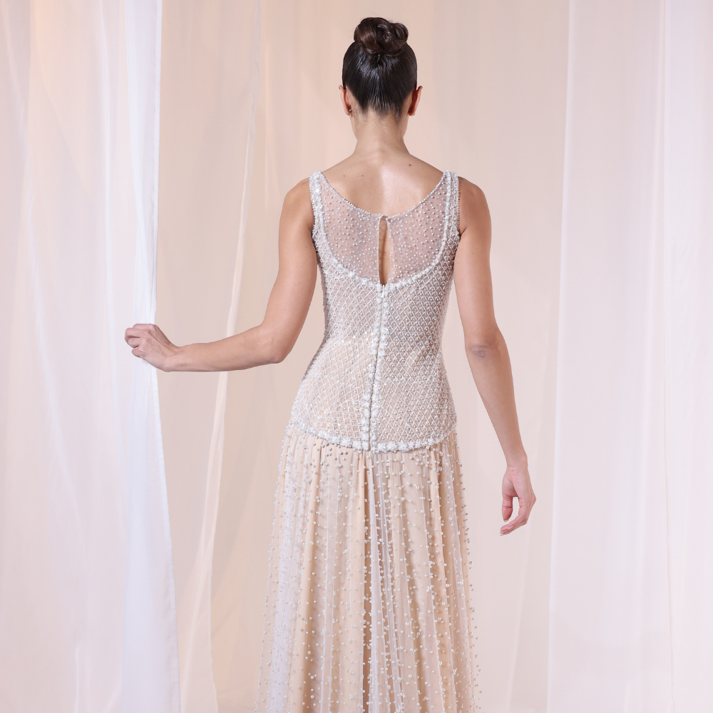 Shop online nude-toned gown with intricate beadwork, delicate textures and flowing embellished layers, perfect for parties and special occasions.