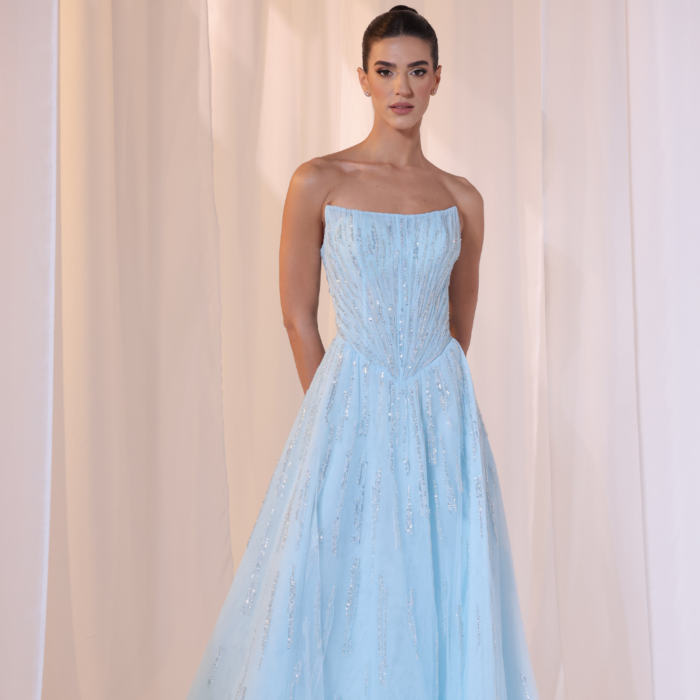 Shop online soft sky-blue gown with structured strapless bodice, shimmer details and flowing embellished skirt, perfect for parties and special occasions.