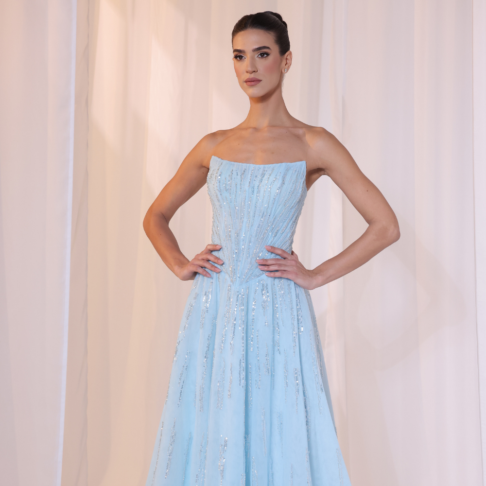 Shop online soft sky-blue gown with structured strapless bodice, shimmer details and flowing embellished skirt, perfect for parties and special occasions.