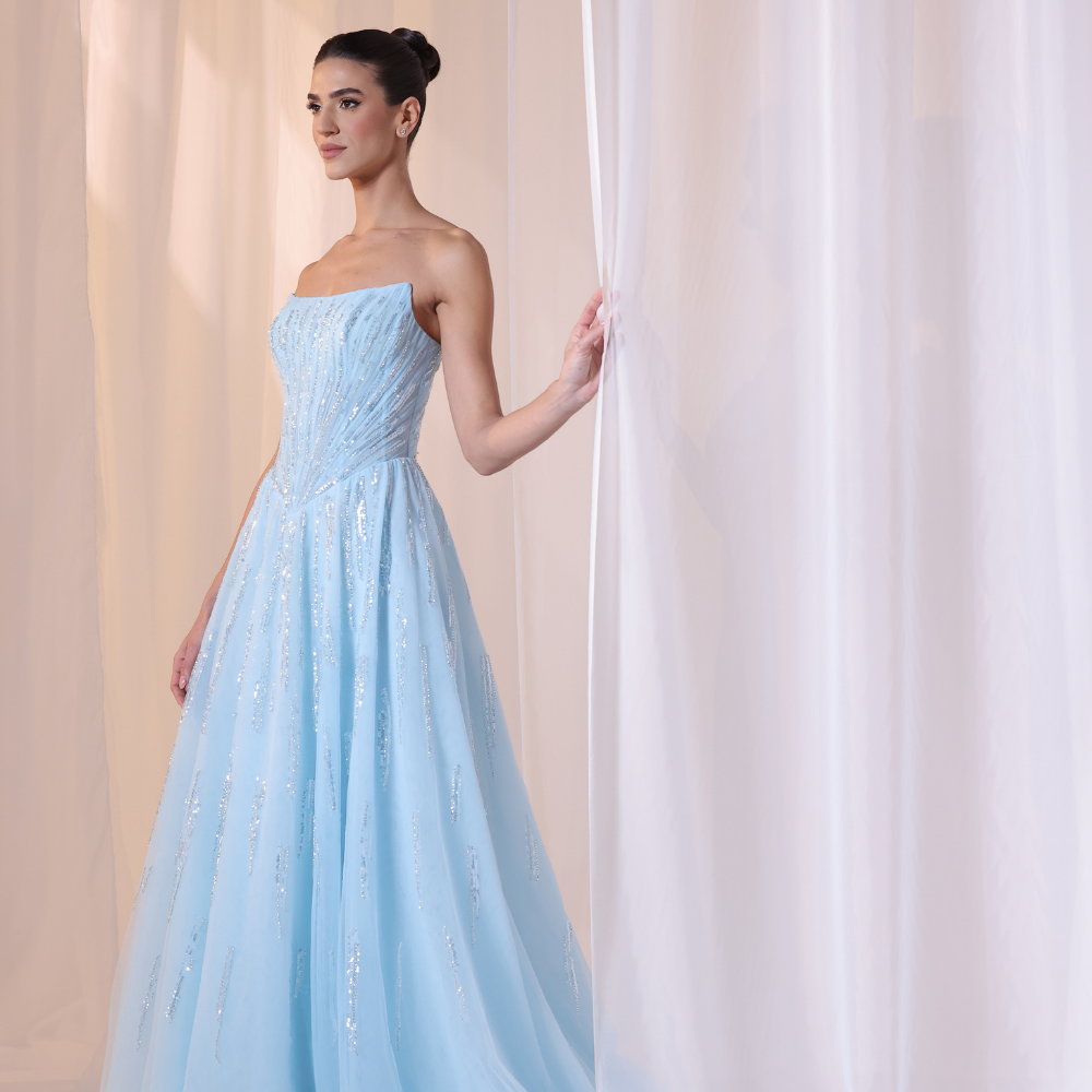 Shop online soft sky-blue gown with structured strapless bodice, shimmer details and flowing embellished skirt, perfect for parties and special occasions.